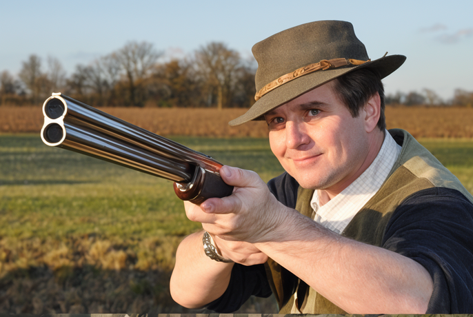 Battista Rizzini shouldering a shotgun, archival